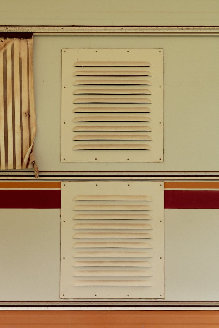 Close-up of home wall with decorative air vents and vintage accents.